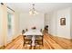 Well lit dining room featuring hardwood floors, a modern light fixture, and an open view to the hallway at 2913 Escondido Farm Rd, Garner, NC 27529