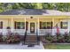 Inviting front porch with brick steps, white railing, and beautiful flowering shrubs at 2913 Escondido Farm Rd, Garner, NC 27529