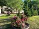 Charming home exterior with colorful flowers and lush greenery enhances the curb appeal at 2913 Escondido Farm Rd, Garner, NC 27529