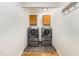 Modern laundry room with front-load washer/dryer sets and wooden cabinets for storage at 2913 Escondido Farm Rd, Garner, NC 27529