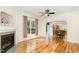Bright living room featuring hardwood floors, a fireplace, a ceiling fan, and an open view to the dining area at 2913 Escondido Farm Rd, Garner, NC 27529