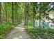 Secluded gravel path through the woods with a view of the pond at 2913 Escondido Farm Rd, Garner, NC 27529