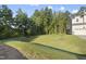 Large, grassy backyard adjacent to a wooded area at 300 Scotland Dr, Youngsville, NC 27596