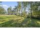 View of the backyard from a distance showing the home at 300 Scotland Dr, Youngsville, NC 27596