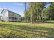 The home's backyard and screened in porch is framed by trees at 300 Scotland Dr, Youngsville, NC 27596