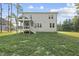The backyard features a screened in porch and stairs leading to the yard at 300 Scotland Dr, Youngsville, NC 27596