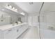 Elegant bathroom featuring double vanities, a glass-enclosed shower, and a separate tub for a relaxing soak at 300 Scotland Dr, Youngsville, NC 27596