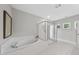 Bright bathroom featuring a glass shower, luxurious tub, and views from windows near the vaulted ceiling at 300 Scotland Dr, Youngsville, NC 27596