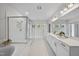 Luminous bathroom featuring double vanity, glass-enclosed shower, and soaking tub, all with modern finishes at 300 Scotland Dr, Youngsville, NC 27596
