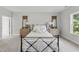 Comfortable bedroom features plush carpeting, decorative nightstands with lamps, and bright natural light at 300 Scotland Dr, Youngsville, NC 27596