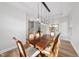 Elegant dining room featuring a wood table, seating for eight, and a modern chandelier at 300 Scotland Dr, Youngsville, NC 27596