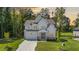 Charming two-story home with a stone-accented garage and a welcoming front porch with columns at 300 Scotland Dr, Youngsville, NC 27596