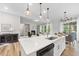 Kitchen island featuring bar seating, a sink, and an open view to the living room and dining area at 300 Scotland Dr, Youngsville, NC 27596
