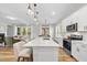 Open concept kitchen with a large island, modern appliances, and views of the living room at 300 Scotland Dr, Youngsville, NC 27596