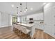 Bright kitchen with stainless appliances, island with breakfast bar, and modern pendant lighting at 300 Scotland Dr, Youngsville, NC 27596
