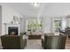 Cozy living room with fireplace, hardwood floors, and ample natural light at 300 Scotland Dr, Youngsville, NC 27596