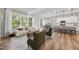 Bright living room connects to the kitchen, featuring an open concept with large windows at 300 Scotland Dr, Youngsville, NC 27596
