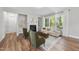 Open-concept living room with hardwood floors, natural light, and modern fireplace at 300 Scotland Dr, Youngsville, NC 27596