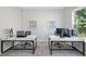 Home office with two workstations, neutral walls, and natural light from a window at 300 Scotland Dr, Youngsville, NC 27596