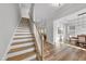 Open concept living room with wooden staircase, recessed lighting, and hardwood flooring at 300 Scotland Dr, Youngsville, NC 27596