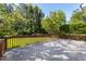 A spacious wooden deck overlooks the manicured backyard, surrounded by lush greenery and mature trees at 30150 Walser, Chapel Hill, NC 27517