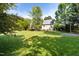 Expansive backyard with lush lawn and mature trees, perfect for outdoor activities at 30150 Walser, Chapel Hill, NC 27517
