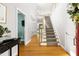 Elegant foyer with hardwood floors, staircase, and views into other rooms, creating an open and inviting space at 30150 Walser, Chapel Hill, NC 27517