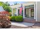 Inviting front porch with brick steps, an American flag, and a swing, perfect for relaxing outdoors at 30150 Walser, Chapel Hill, NC 27517
