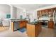 Bright and open kitchen with wood cabinetry, granite countertops, and a convenient island with barstool seating at 30150 Walser, Chapel Hill, NC 27517