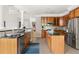 Spacious kitchen with wood cabinetry, stainless steel appliances, and an open layout connecting to the living areas at 30150 Walser, Chapel Hill, NC 27517