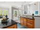 Bright eat-in kitchen boasts wood cabinets, granite countertops, stainless steel appliances, and backyard access at 30150 Walser, Chapel Hill, NC 27517