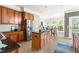 Well-lit kitchen with wooden cabinetry, stainless steel appliances, and an island with a black countertop at 30150 Walser, Chapel Hill, NC 27517