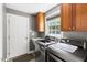 Well-equipped laundry room with modern washer and dryer, storage cabinets and a sink for added convenience at 30150 Walser, Chapel Hill, NC 27517