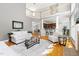 Open-concept living room featuring a fireplace, hardwood floors, and a view of the kitchen and dining area at 30150 Walser, Chapel Hill, NC 27517