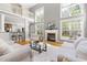 Spacious living room with a fireplace, tall windows, hardwood floors, and access to the kitchen and upstairs at 30150 Walser, Chapel Hill, NC 27517
