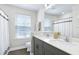 Bright bathroom featuring double sinks with gray vanity, wood-look tile flooring, and a shower with a decorative curtain at 3017 Ginger Hill Ln, Durham, NC 27703