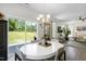 Dining room with a white round table, stylish chairs, and sliding glass doors that lead to the backyard at 3017 Ginger Hill Ln, Durham, NC 27703