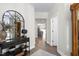 Inviting hallway featuring a decorative mirror, a console table, and hardwood flooring at 3017 Ginger Hill Ln, Durham, NC 27703