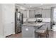 Modern kitchen featuring gray cabinets, granite countertops, stainless steel appliances, and an island with bar seating at 3017 Ginger Hill Ln, Durham, NC 27703