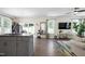 Open-concept living space featuring a kitchen island, dining area, and living room with ample natural light at 3017 Ginger Hill Ln, Durham, NC 27703