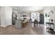 Open-concept living space with modern kitchen, dining area, and a view of the backyard through sliding glass doors at 3017 Ginger Hill Ln, Durham, NC 27703
