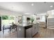 Open-concept living space including a modern kitchen with island, dining area, and cozy living room at 3017 Ginger Hill Ln, Durham, NC 27703