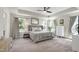 Bright main bedroom offers a ceiling fan, generous natural light, and neutral decor at 3017 Ginger Hill Ln, Durham, NC 27703