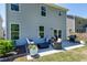 Backyard patio with outdoor seating, a grill, and access to the house through sliding glass doors, perfect for entertaining at 3017 Ginger Hill Ln, Durham, NC 27703