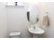 Clean powder room with a pedestal sink, oval mirror, and a neutral color scheme at 3017 Ginger Hill Ln, Durham, NC 27703