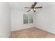 Neutral bedroom featuring a ceiling fan and natural light from the window at 302 Red Elm Dr, Durham, NC 27713