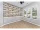 Bright dining area featuring a ceiling fan, large windows, and decorative shiplap wall at 302 Red Elm Dr, Durham, NC 27713