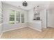 Bright dining area with a ceiling fan, large windows, and neutral tile flooring at 302 Red Elm Dr, Durham, NC 27713