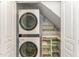 Functional laundry area with stacked washer and dryer, plus convenient built-in storage shelves at 302 Red Elm Dr, Durham, NC 27713