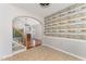 Open-concept living area showcasing a fireplace, hardwood floors, and an archway entrance at 302 Red Elm Dr, Durham, NC 27713
